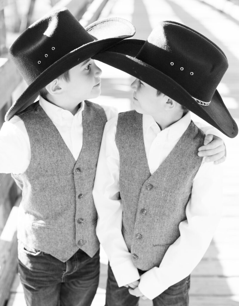 Two brothers stand on bridge in City park looking at each other