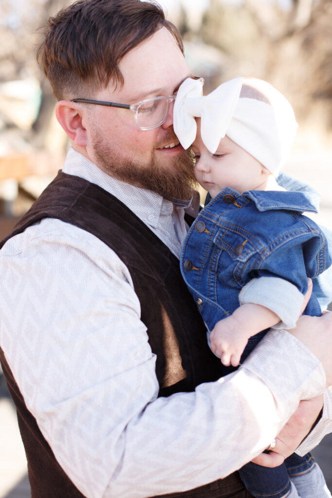 Dad holds baby at family session in City Park