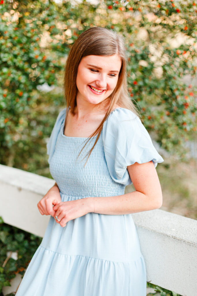 Girl smiles down shoulder