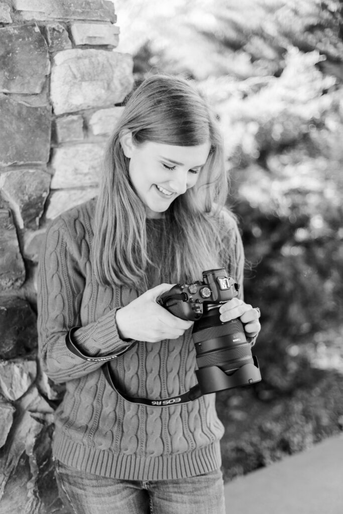 Girl smiles down at her camera