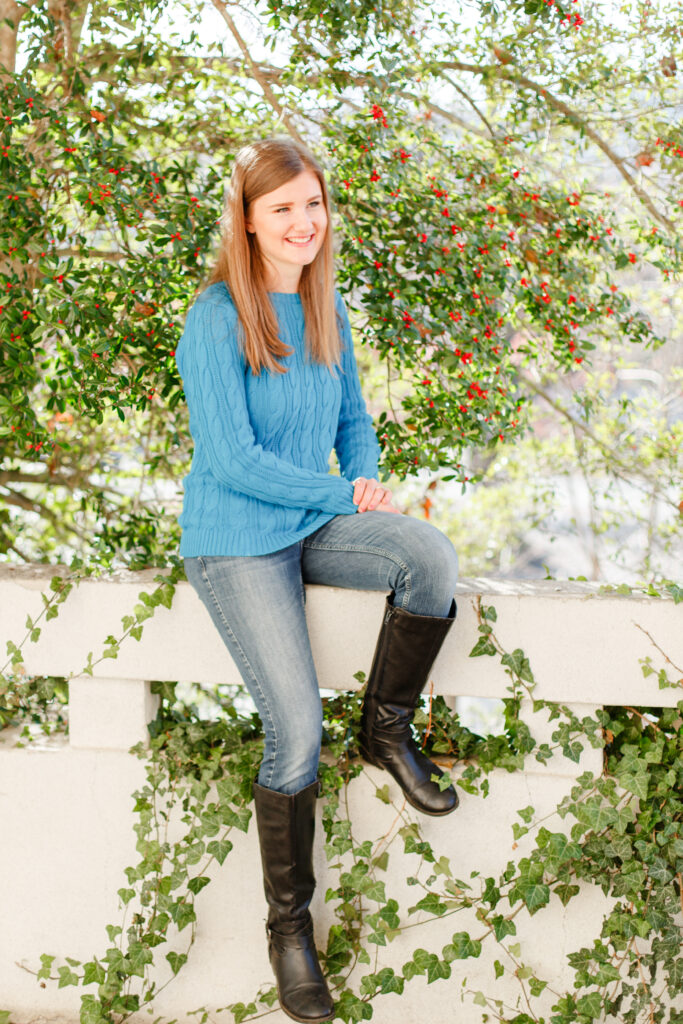 Girl sits on low wall