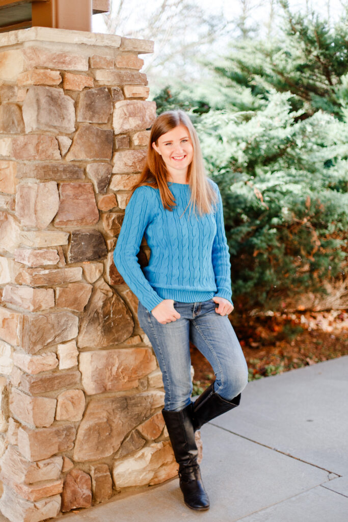 Girl leans on brick wall