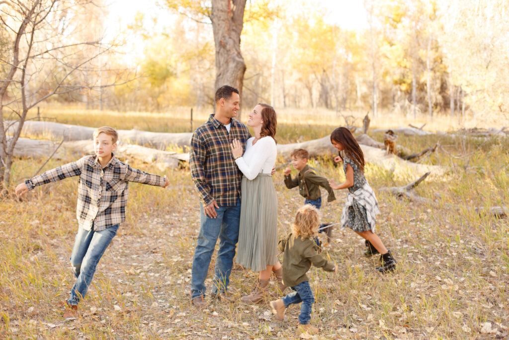 Kids run around mom and dad at fall family session at City Park CO. 2023 favorites