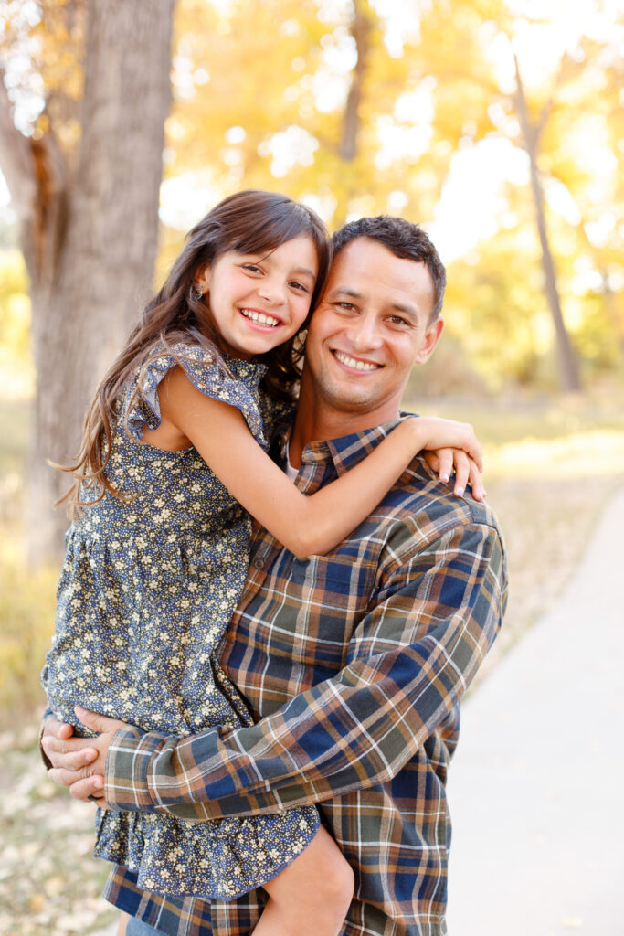 Dad holds daughter in City Park fall family session