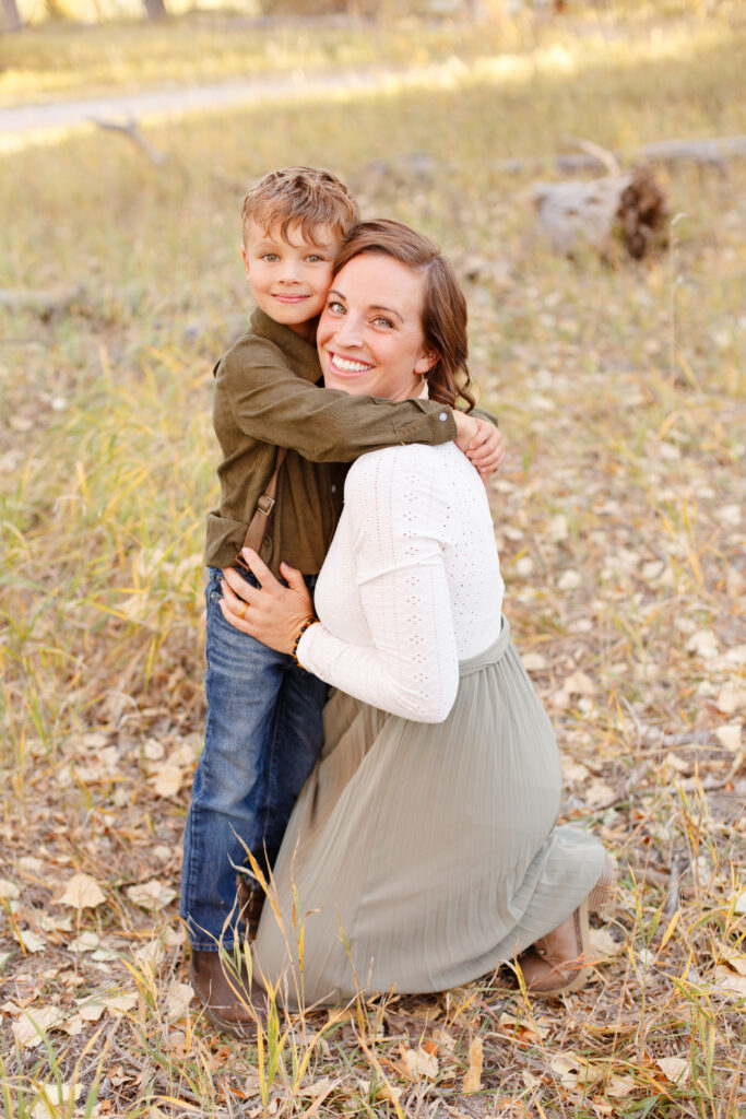 Son hugs mom at fall family session in City Park