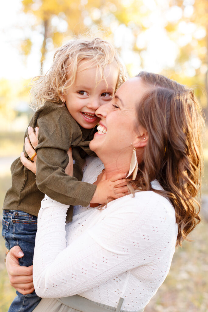 Mom and toddler laugh together at Fall family session in Pueblo CO