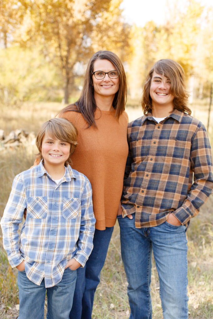 Mom and sons smile at camera in City Park