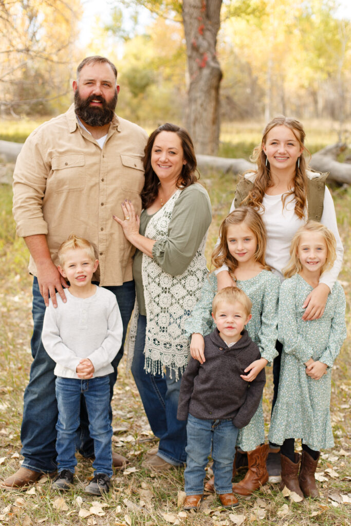 Family smiles at the camera in Pueblo CO