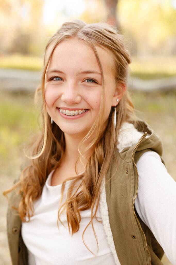 Girl smiles at fall family session in Pueblo CO. 