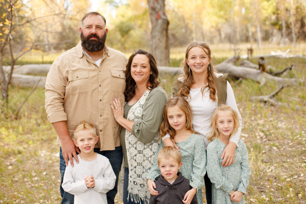 Family smiles at camera in City Park