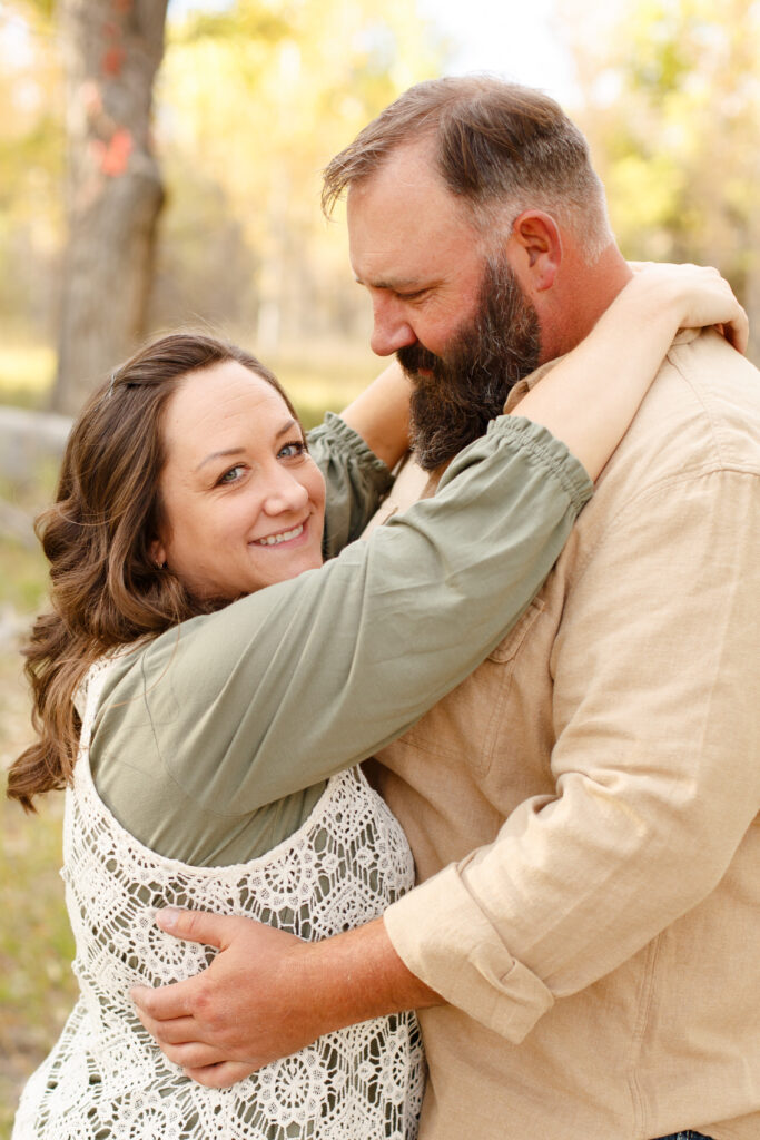 Dad gives mom a hug a family session.