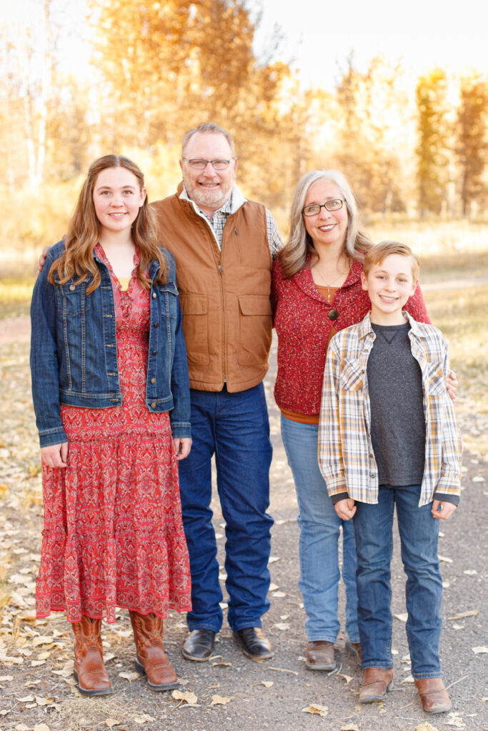 Family stand together at fall family mini session in City Park, Pueblo CO