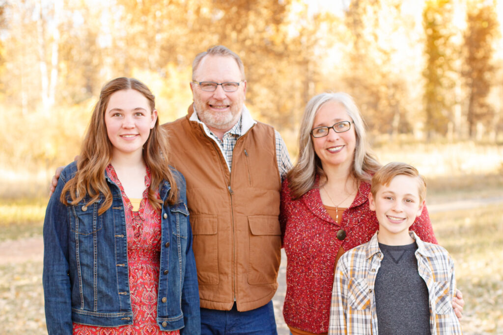 Family smiles at fall family mini session in City Park, Pueblo CO