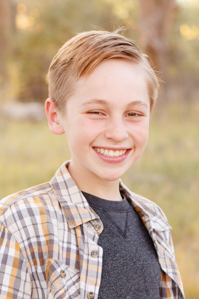 Boy smiles in City Park, Pueblo CO