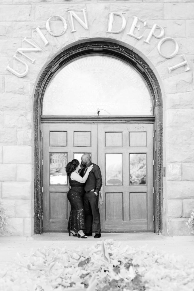 Couple smiles at each other at the Union Depot in Pueblo CO. 2023 favorites