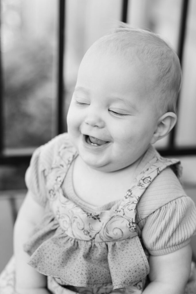 Baby laughs with eyes closed in Pueblo West CO