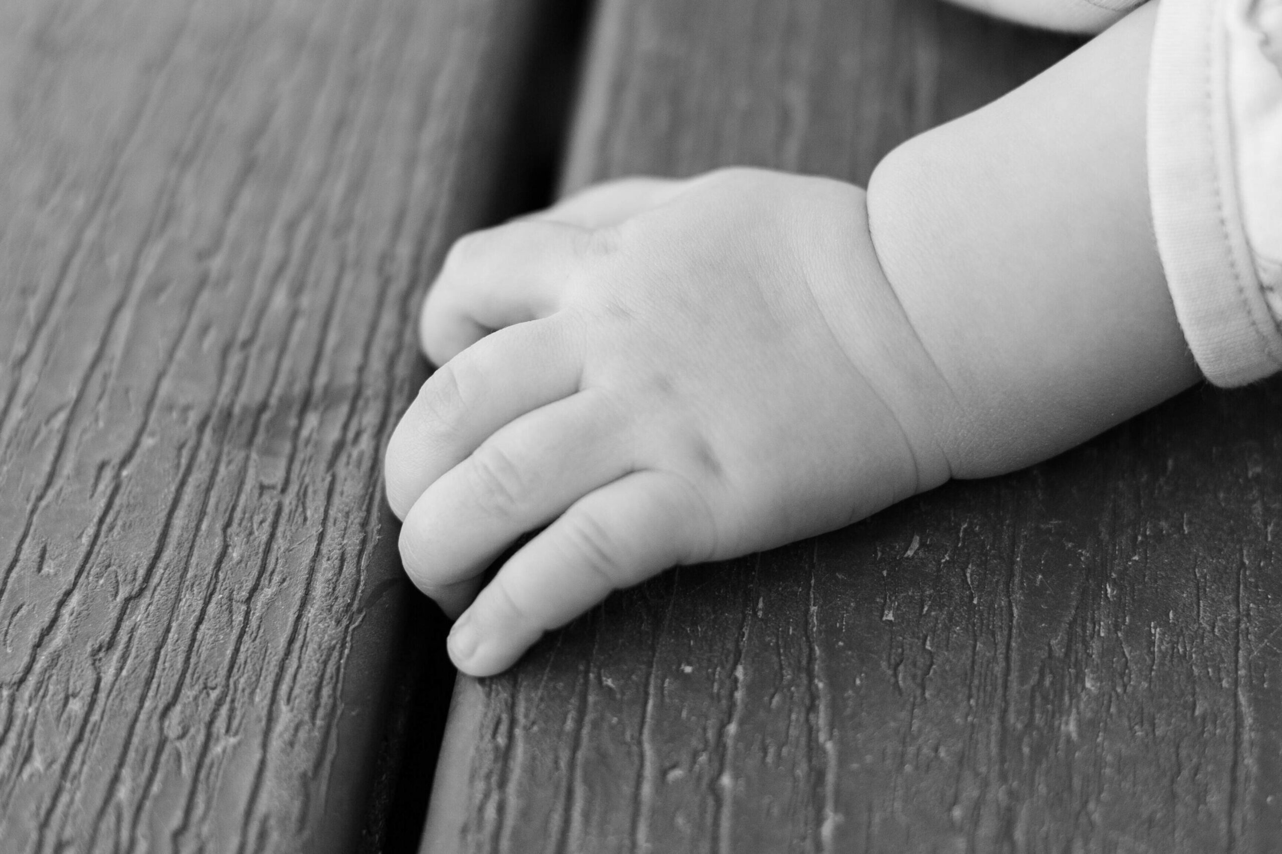 Baby's hand at milestone mirror session. Pueblo CO