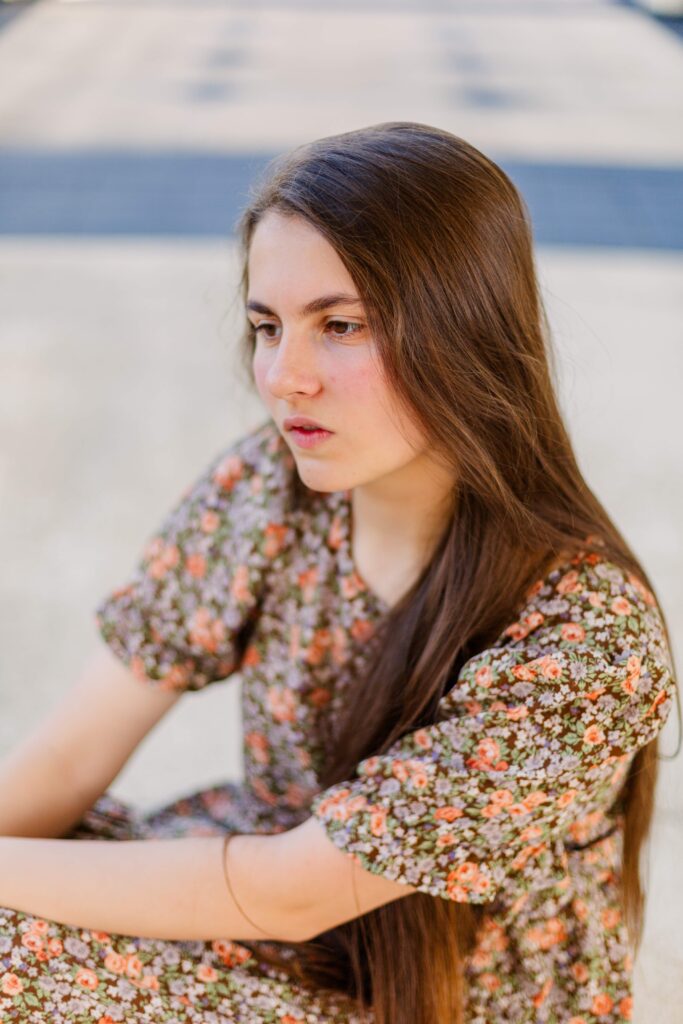 Girl stares into the distance in scenic destination session.