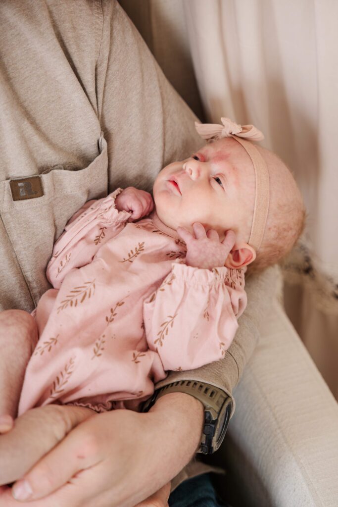 Newborn rest in Dad's arm during in home newborn session