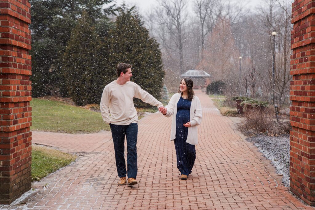 Husband leads his wife down a path.