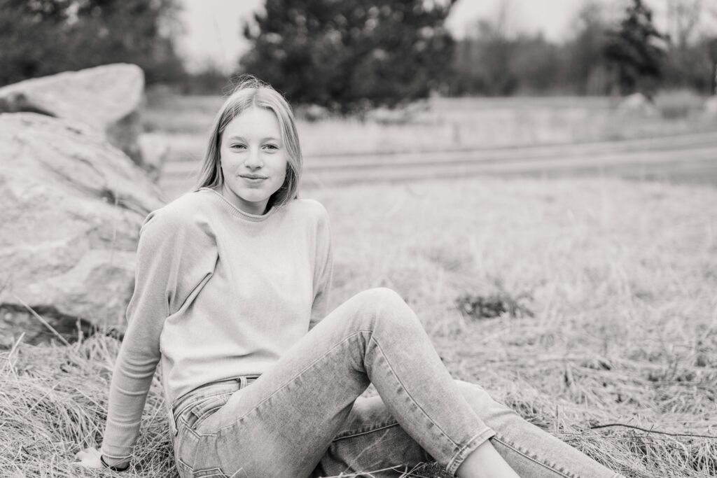 Girl leans back while sitting