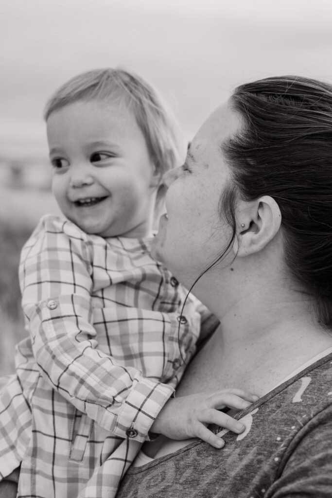 Black and white of Mom holding the youngest.