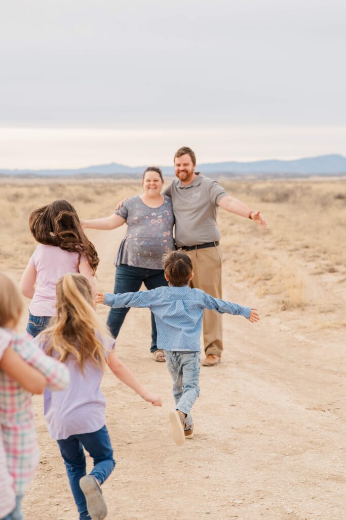Kids run towards Mom and Dad.