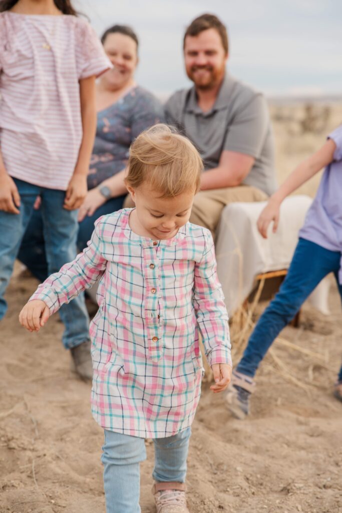 Toddler stomps in the dirt.