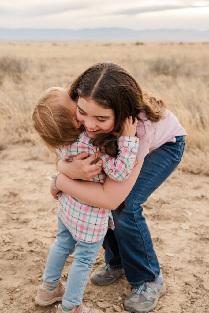 Oldest hugs the youngest.