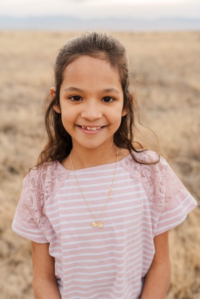The second child smiles at the camera.
