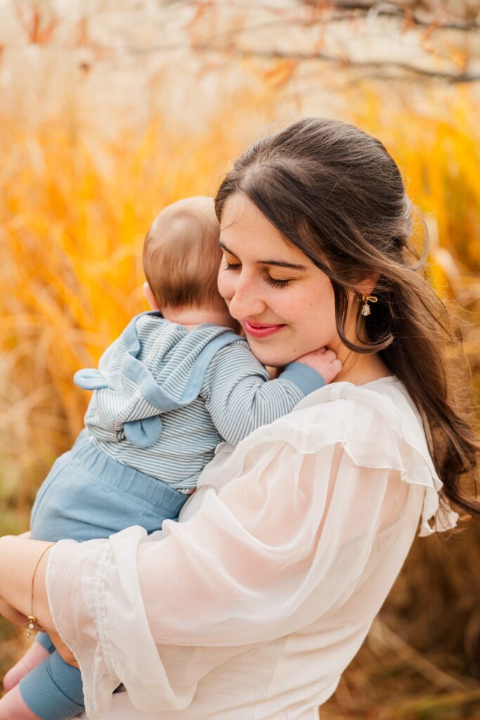 Mama snuggles baby and rocks back and forth.