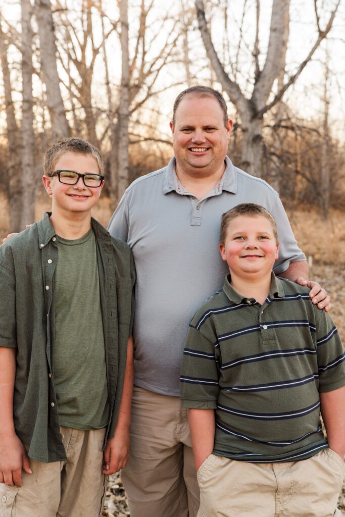 Dad and sons smile.