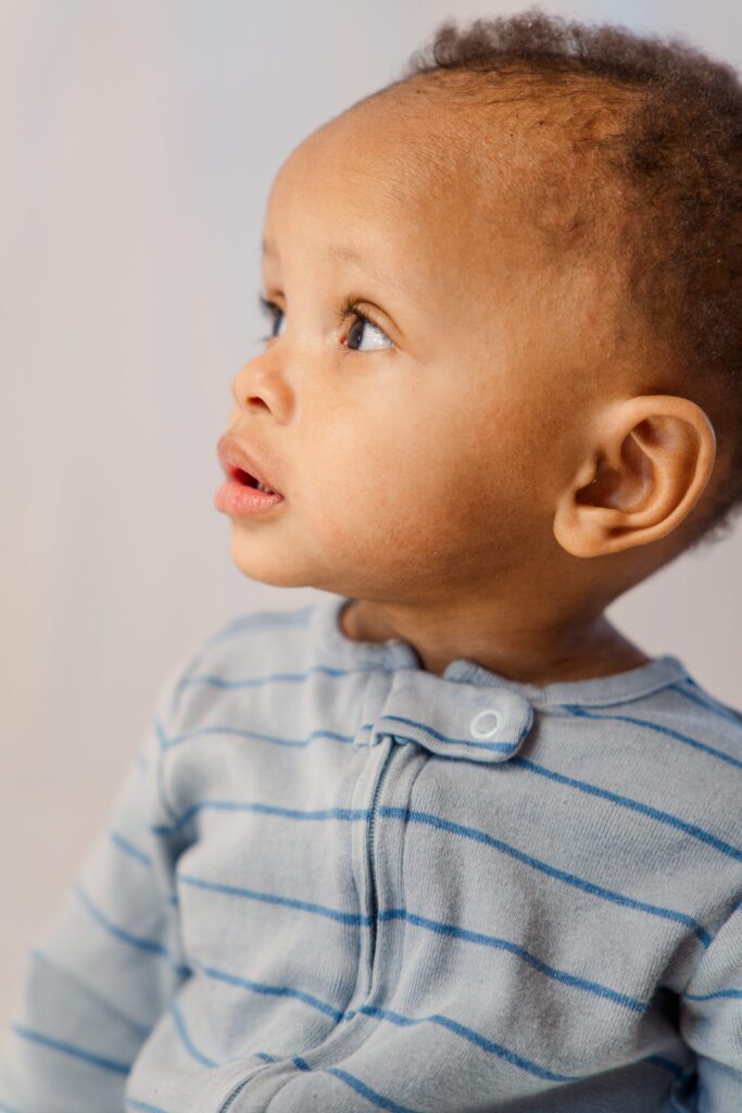 Baby boy looks off to the side