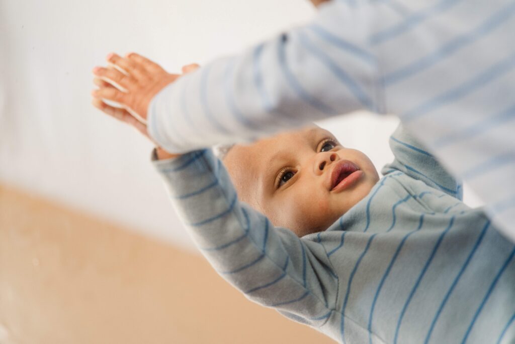 During baby photos Pueblo West, baby looks down at the mirror