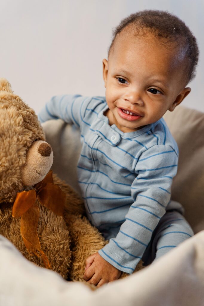 Baby laughs while sitting in a basket.